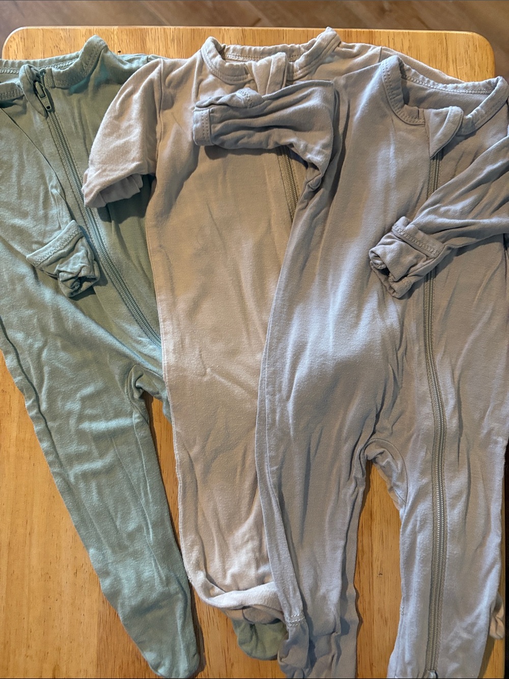 Lot of 3 NB Kyte Baby zippered one piece footies.